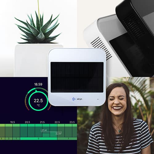 Airynin pieni mittauslaite taustalla muun muassa hymyilevä nainen